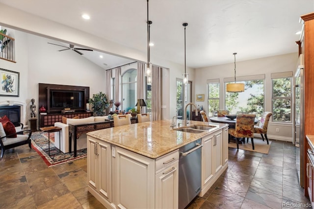 kitchen featuring a sink, stone tile floors, open floor plan, and dishwasher