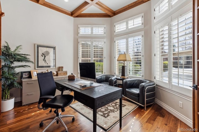 office featuring coffered ceiling, a healthy amount of sunlight, hardwood / wood-style flooring, and beamed ceiling