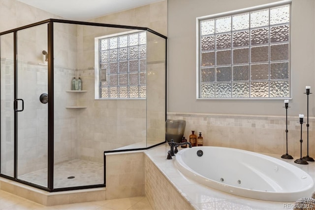 full bath with a tub with jets and a stall shower