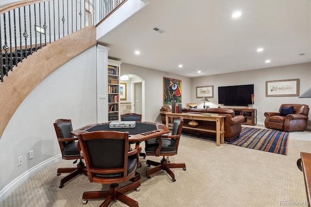 dining space with arched walkways, recessed lighting, carpet, and visible vents