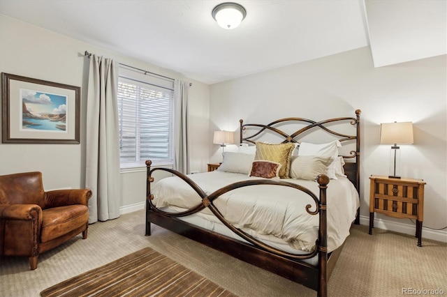 bedroom with baseboards and light colored carpet