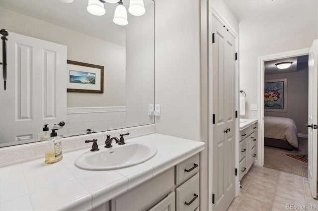 full bathroom with vanity, connected bathroom, tile patterned floors, and a chandelier