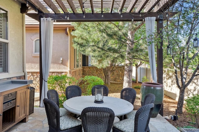 view of patio with fence, a pergola, and outdoor dining area