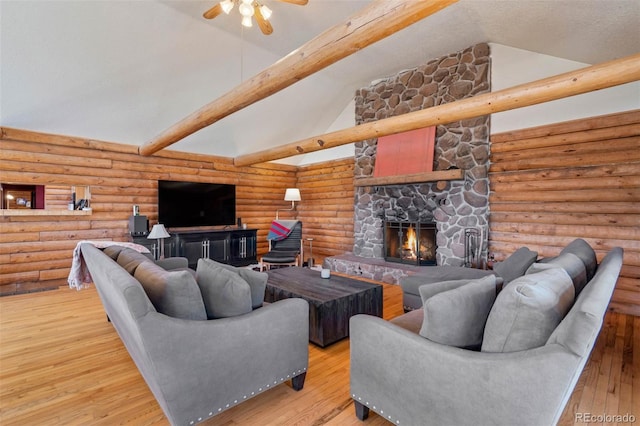 660 Wagon Wheel Rd, Guffey, CO 80820 - living area with ceiling fan, a stone fireplace, hardwood / wood-style floors, and log walls