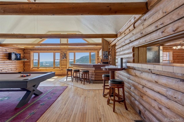 660 Wagon Wheel Rd, Guffey, CO 80820 - playroom featuring log walls, healthy amount of natural light, wood-type flooring, pool table, and a bar