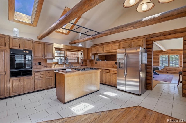 660 Wagon Wheel Rd, Guffey, CO 80820 - kitchen featuring stainless steel appliances, a warming drawer, a skylight, light countertops, and beamed ceiling