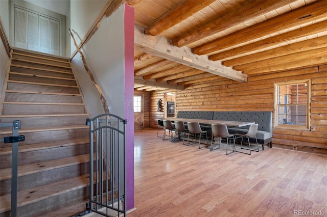 660 Wagon Wheel Rd, Guffey, CO 80820 - stairway with rustic walls, wood finished floors, and a wooden ceiling with exposed beams