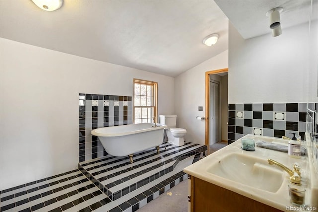 660 Wagon Wheel Rd, Guffey, CO 80820 - full bathroom with a freestanding bath, vanity, lofted ceiling, and tile walls