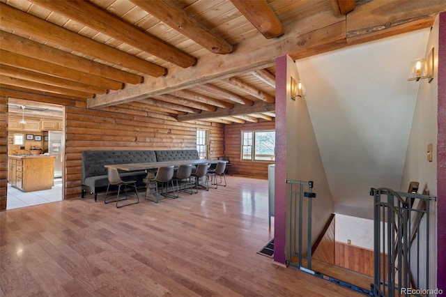 660 Wagon Wheel Rd, Guffey, CO 80820 - dining space featuring a wood ceiling with exposed beams, light wood-style floors, and log walls