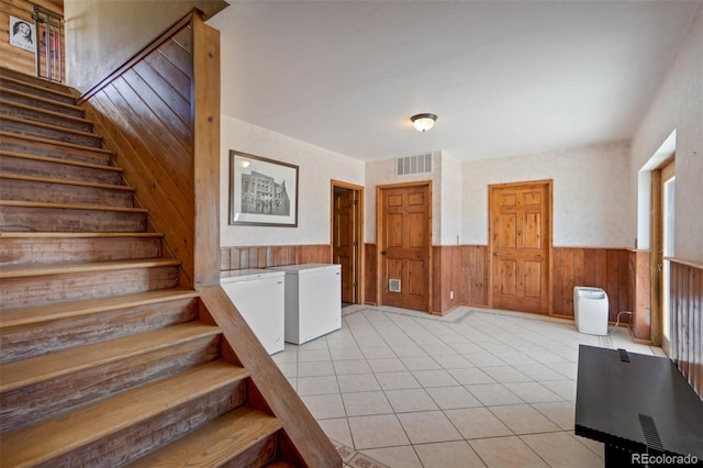 660 Wagon Wheel Rd, Guffey, CO 80820 - stairway featuring wainscoting, wooden walls, and tile patterned flooring