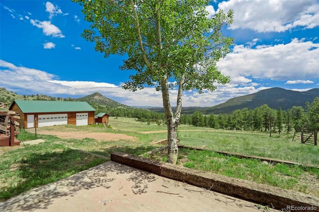 660 Wagon Wheel Rd, Guffey, CO 80820 - view of yard featuring a mountain view, an outdoor structure, a view of rural / pastoral area, and dirt driveway