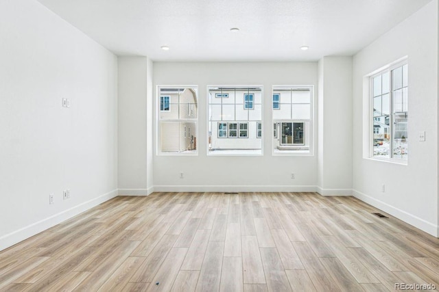 unfurnished room with light hardwood / wood-style flooring