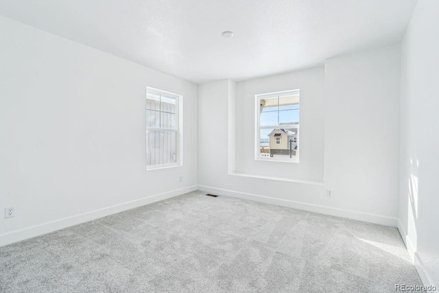 unfurnished room with light colored carpet