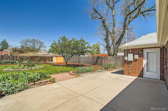 5703 Ammons St, Arvada, CO 80002 - view of patio with a fenced backyard, an outbuilding, and a shed