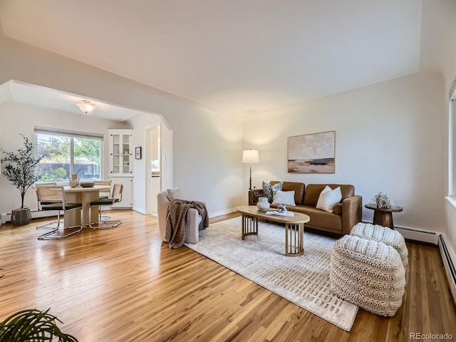5703 Ammons St, Arvada, CO 80002 - living area featuring light wood-type flooring, baseboards, and arched walkways