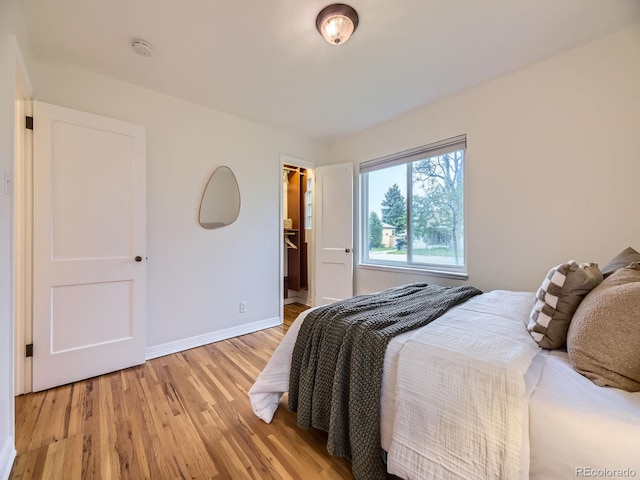 5703 Ammons St, Arvada, CO 80002 - bedroom with light wood-style floors, baseboards, a spacious closet, and a closet