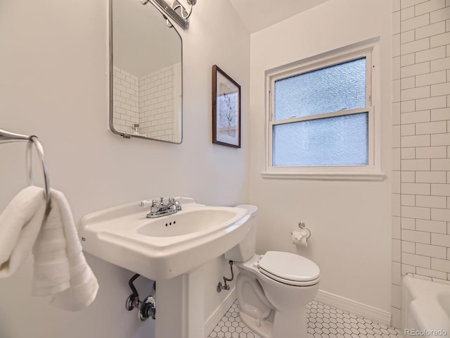 5703 Ammons St, Arvada, CO 80002 - bathroom featuring baseboards, toilet, and tile patterned flooring