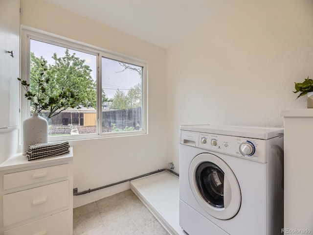 5703 Ammons St, Arvada, CO 80002 - laundry area with washer / clothes dryer and light tile patterned floors