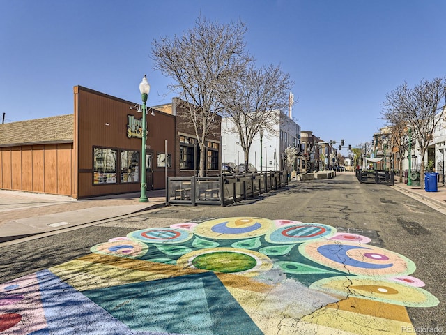 5703 Ammons St, Arvada, CO 80002 - view of asphalt street featuring street lighting, a residential view, curbs, and sidewalks