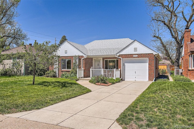 5703 Ammons St, Arvada, CO 80002 - view of front facade with brick siding, an attached garage, driveway, and covered porch