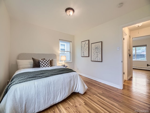 5703 Ammons St, Arvada, CO 80002 - bedroom with wood finished floors, attic access, baseboards, and baseboard heating