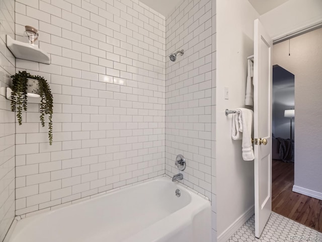 5703 Ammons St, Arvada, CO 80002 - full bathroom with shower / bath combination, baseboards, and wood finished floors