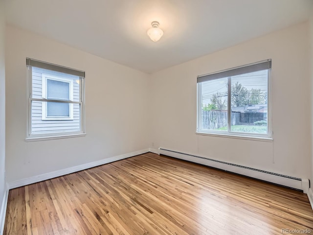 5703 Ammons St, Arvada, CO 80002 - unfurnished room featuring light wood-style flooring, a baseboard radiator, and baseboards