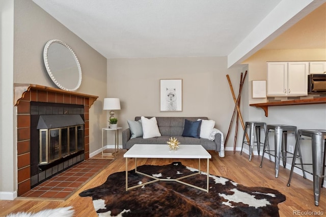 840 S Vance St Unit A, Lakewood, CO 80226 - living area with baseboards, a fireplace, and wood finished floors