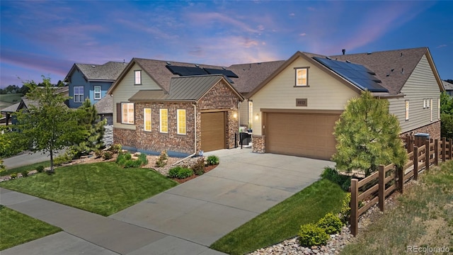 8142 S Langdale Way, Aurora, CO 80016 - view of front of house featuring concrete driveway, solar panels, a garage, and stone siding
