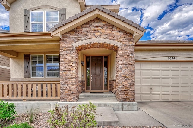 view of exterior entry with a garage