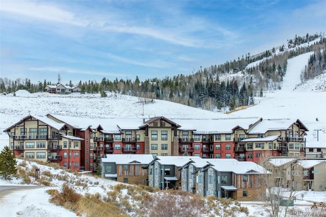 snowy aerial view with a residential view