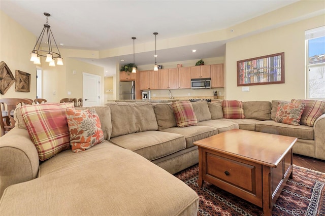 living area with dark wood-type flooring and recessed lighting