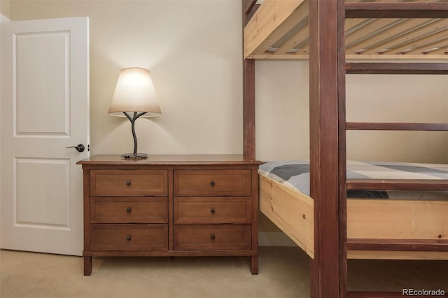 bedroom featuring light colored carpet