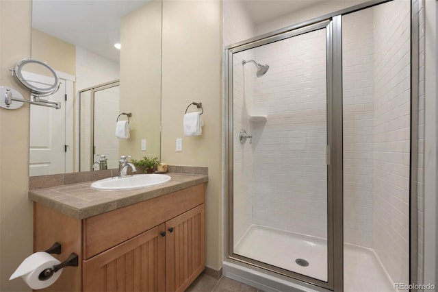 full bath with tile patterned flooring, a shower stall, and vanity