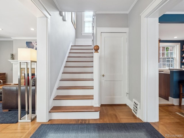 724 N Franklin St, Denver, CO 80218 - staircase with plenty of natural light, wood finished floors, and ornamental molding
