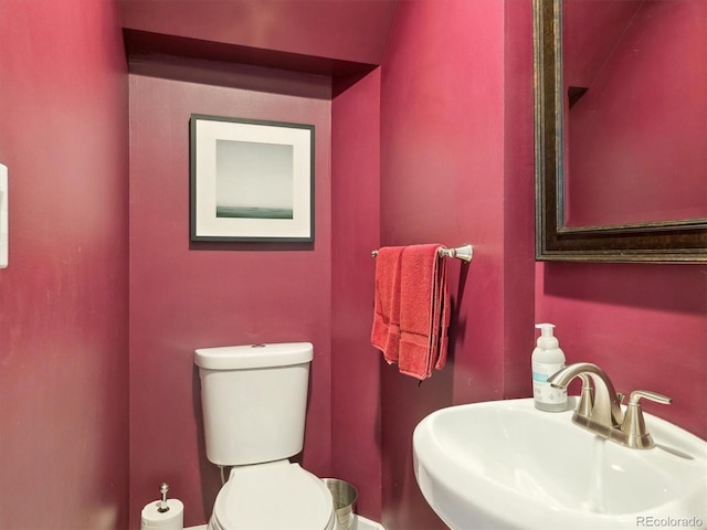 724 N Franklin St, Denver, CO 80218 - half bathroom featuring a sink, toilet, and baseboards