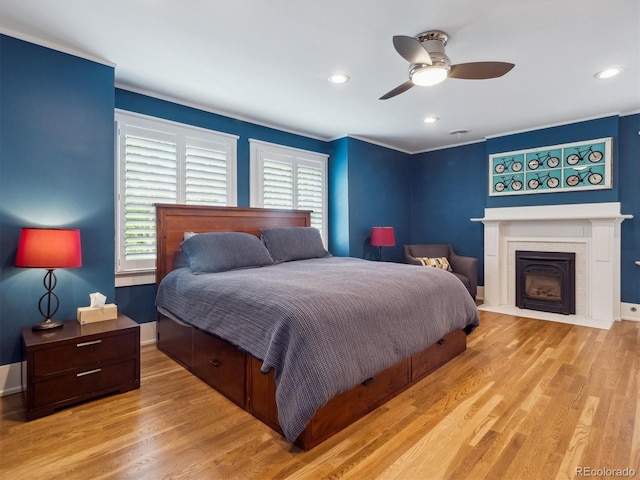 724 N Franklin St, Denver, CO 80218 - bedroom with multiple windows, wood finished floors, a fireplace with flush hearth, and recessed lighting