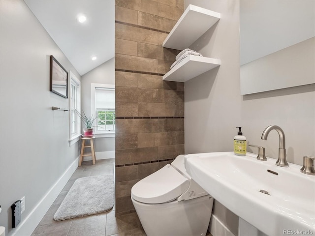 724 N Franklin St, Denver, CO 80218 - bathroom with toilet, a sink, vaulted ceiling, baseboards, and tile patterned floors