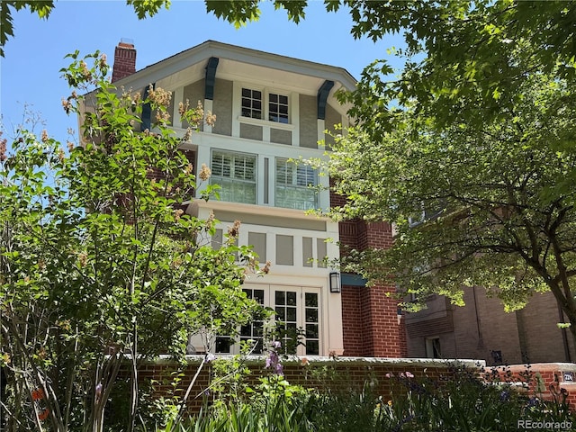 724 N Franklin St, Denver, CO 80218 - back of house featuring stucco siding, a chimney, and brick siding