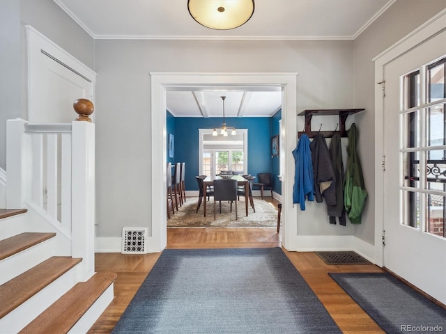 724 N Franklin St, Denver, CO 80218 - entryway with wood finished floors, a chandelier, stairway, baseboards, and crown molding