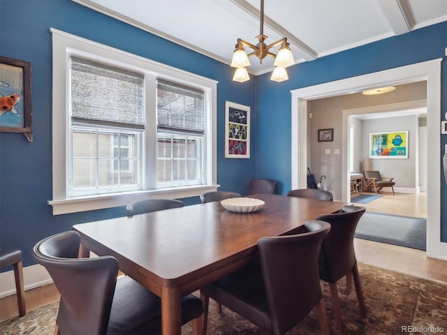 724 N Franklin St, Denver, CO 80218 - dining space featuring wood finished floors, a chandelier, baseboards, and crown molding
