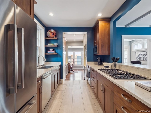 724 N Franklin St, Denver, CO 80218 - kitchen with appliances with stainless steel finishes, a sink, brown cabinetry, light stone countertops, and open shelves