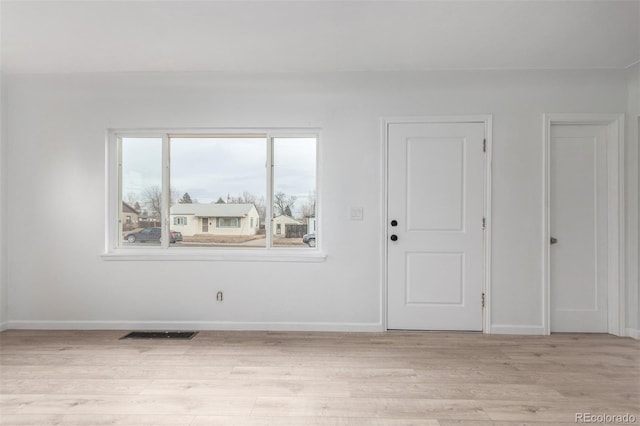 spare room with light hardwood / wood-style flooring