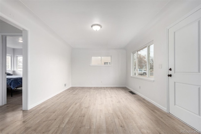 empty room featuring a healthy amount of sunlight and light wood-type flooring