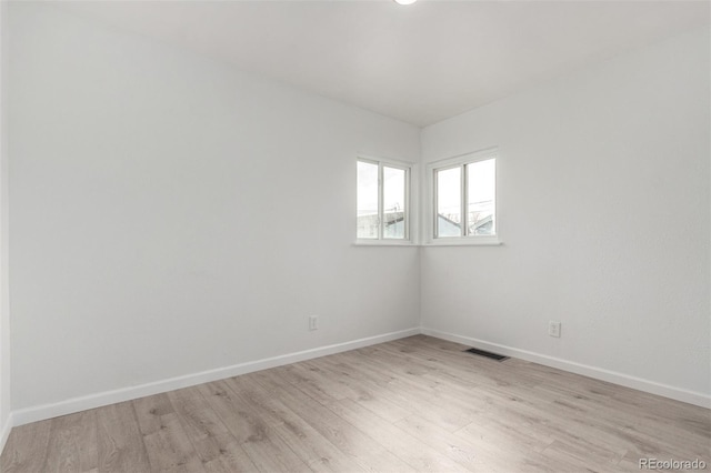 empty room with light hardwood / wood-style flooring