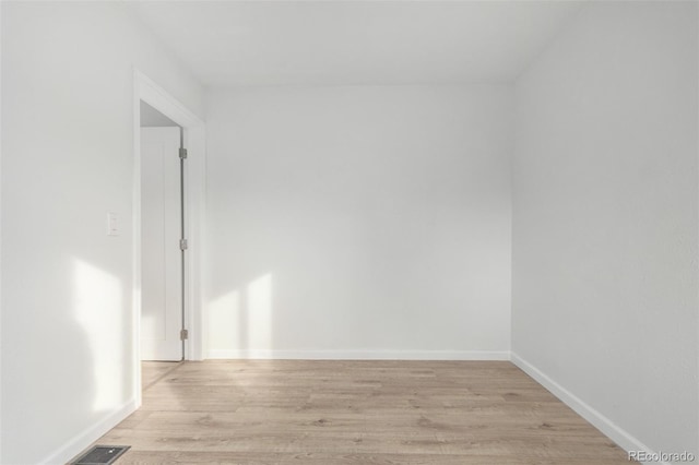 spare room with light hardwood / wood-style floors