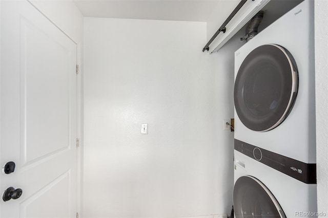 laundry area with stacked washer and dryer