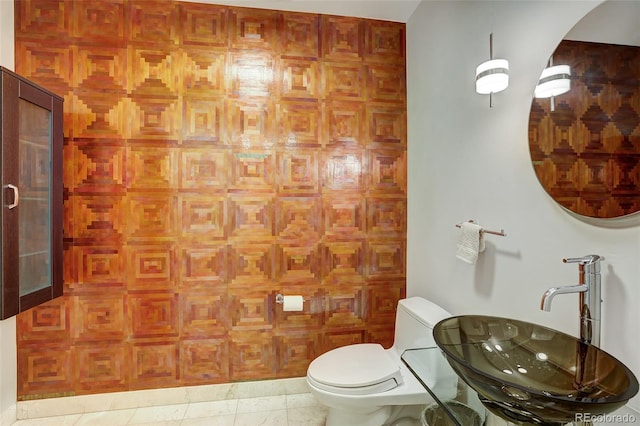 bathroom with tile patterned flooring, sink, and toilet