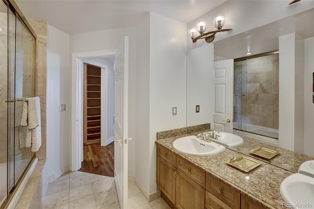 bathroom featuring vanity, tile patterned flooring, and a shower with door