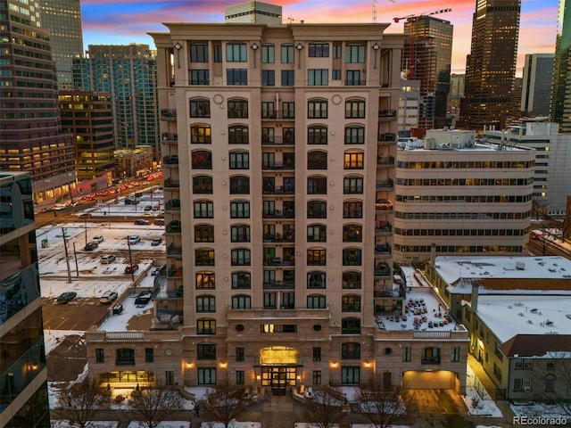 property at dusk featuring a view of city